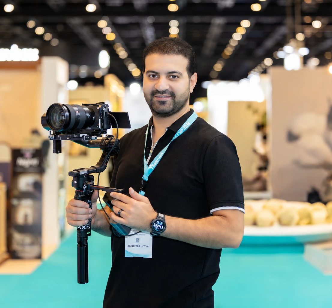 Ibrahim El Bedewy working as a videographer at a UAE exhibition